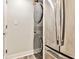 Convenient laundry area featuring stacked washer and dryer, stainless steel appliances, and ample storage space at 1 Biscayne Drive Nw # 706, Atlanta, GA 30309