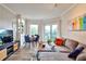 Cozy living room includes a comfortable sectional sofa, a dining table, and a balcony with views of the neighborhood at 1 Biscayne Drive Nw # 706, Atlanta, GA 30309