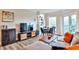 Bright and modern living room with dining area, built-in shelving, comfortable seating, and access to a balcony at 1 Biscayne Drive Nw # 706, Atlanta, GA 30309