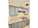 Kitchen with gray cabinets, stainless steel sink, and granite countertops at 106 Plantation Dr, Clarkston, GA 30021