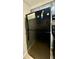 A standard, black refrigerator/freezer combo with a small freezer sits in the corner of this kitchen at 106 Plantation Dr, Clarkston, GA 30021