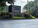Stone community sign for River West Condominiums with manicured landscaping and street view at 1201 River Green Nw Dr, Atlanta, GA 30327
