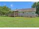 Spacious backyard featuring a covered porch and ample green space, perfect for outdoor activities at 487 Laney Rd, Locust Grove, GA 30248