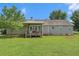 Large, lush backyard featuring a covered back porch and green lawn at 487 Laney Rd, Locust Grove, GA 30248