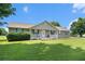 Charming single-story home featuring a well-manicured lawn and inviting front porch with rocking chairs at 487 Laney Rd, Locust Grove, GA 30248