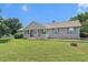 Charming single-story home featuring a well-manicured lawn and inviting front porch with rocking chairs at 487 Laney Rd, Locust Grove, GA 30248
