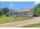 Charming home with a welcoming front porch, attached garage, and well-manicured lawn at 487 Laney Rd, Locust Grove, GA 30248