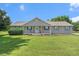 Charming single-story home featuring a well-manicured lawn and inviting front porch with rocking chairs at 487 Laney Rd, Locust Grove, GA 30248