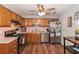 Functional kitchen with stainless steel appliances, warm wood cabinets, and hardwood floors at 487 Laney Rd, Locust Grove, GA 30248
