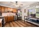 Functional kitchen with stainless steel appliances, warm wood cabinets, and checkered curtains at 487 Laney Rd, Locust Grove, GA 30248