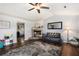 Spacious living room with plank flooring, a ceiling fan, and a brick fireplace at 487 Laney Rd, Locust Grove, GA 30248