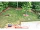 Expansive, fenced backyard with lush green lawn, mature trees and patio at 655 Stone Harbor Sw Pkwy, Marietta, GA 30060
