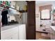 Functional bathroom featuring vanity, toilet, and laundry machines at 655 Stone Harbor Sw Pkwy, Marietta, GA 30060