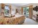 Bright bedroom with large windows offering views of the manicured yard at 655 Stone Harbor Sw Pkwy, Marietta, GA 30060