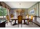 Formal dining room with chandelier, striped wallpaper, and large window with draperies at 655 Stone Harbor Sw Pkwy, Marietta, GA 30060