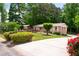 Charming one-story brick home with a well-maintained lawn, mature trees, and long driveway at 655 Stone Harbor Sw Pkwy, Marietta, GA 30060
