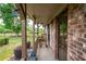 Quaint front porch featuring brick siding, comfortable rocking chair, and a view of the landscaped yard at 655 Stone Harbor Sw Pkwy, Marietta, GA 30060