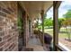 Charming front porch offers relaxing seating, brick detailing, and a pleasant view of the landscaped surroundings at 655 Stone Harbor Sw Pkwy, Marietta, GA 30060