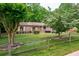 Well-maintained home with lush green lawn, mature trees, and a rustic split rail fence in the front yard at 655 Stone Harbor Sw Pkwy, Marietta, GA 30060