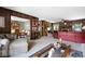 Comfortable living room with wood paneling, plush seating, and view into formal dining area at 655 Stone Harbor Sw Pkwy, Marietta, GA 30060