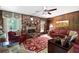 Living room features a brick fireplace, wood paneling, ceiling fan, and decorative furnishings at 655 Stone Harbor Sw Pkwy, Marietta, GA 30060