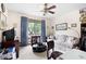 Cozy living room featuring a ceiling fan, floral sofa, and a view to the exterior at 655 Stone Harbor Sw Pkwy, Marietta, GA 30060