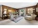 Cozy living room with wood-paneled walls, plush furniture, ample natural light, and a spacious layout at 655 Stone Harbor Sw Pkwy, Marietta, GA 30060
