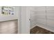 Walk-in closet with wire shelving, with glimpse into an adjacent room with outside view at 116 Crooked Lake Park, Villa Rica, GA 30180