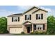 Charming two-story home featuring stone accents, a two-car garage, and a well-manicured lawn at 116 Crooked Lake Park, Villa Rica, GA 30180