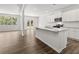 Open-concept kitchen featuring white cabinetry, granite countertops, stainless appliances, and a center island at 116 Crooked Lake Park, Villa Rica, GA 30180