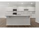 Stylish kitchen boasting white cabinets, granite counters, a large island, and modern appliances at 116 Crooked Lake Park, Villa Rica, GA 30180