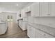 Bright kitchen featuring granite countertops, white cabinets, stainless appliances, and tile backsplash at 116 Crooked Lake Park, Villa Rica, GA 30180