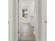 Bright laundry room view from hallway showcasing white cabinets and tile flooring at 116 Crooked Lake Park, Villa Rica, GA 30180