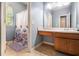 Bright bathroom featuring a vanity, shower with floral curtain, and neutral tiling at 1232 Candler Ct, Morrow, GA 30260