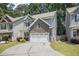 Two-story home featuring stone accents, two-car garage, and an expansive driveway at 1232 Candler Ct, Morrow, GA 30260
