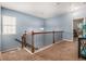 Upstairs hallway features carpet, iron railing, and chandelier at 1232 Candler Ct, Morrow, GA 30260
