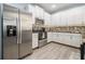 Modern kitchen features stainless steel appliances, white cabinetry, and stylish tile backsplash at 1232 Candler Ct, Morrow, GA 30260