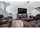 Comfortable living room with wood floors, modern entertainment center, and cozy seating at 1232 Candler Ct, Morrow, GA 30260