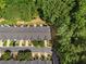Aerial view of townhomes nestled among lush green trees and landscaping at 4221 Rogers Creek Ct, Duluth, GA 30096