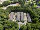 Aerial view of townhome community with lush green trees surrounding the property at 4221 Rogers Creek Ct, Duluth, GA 30096