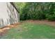 Side yard with a grassy area and view of the home's exterior at 4221 Rogers Creek Ct, Duluth, GA 30096