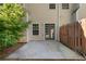 View of the home's backyard featuring a concrete patio and partial wooden fence at 4221 Rogers Creek Ct, Duluth, GA 30096