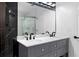 Bathroom featuring marble tile, walk-in shower with glass door, and double sink vanity at 4221 Rogers Creek Ct, Duluth, GA 30096