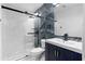 Modern bathroom features marble accents, glass shower, and blue vanity with gold hardware at 4221 Rogers Creek Ct, Duluth, GA 30096