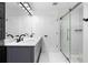 Bathroom featuring marble tile, walk-in shower with glass door, and double sink vanity at 4221 Rogers Creek Ct, Duluth, GA 30096
