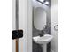 Powder room with stylish marble accent wall and pedestal sink, providing a modern and elegant touch at 4221 Rogers Creek Ct, Duluth, GA 30096
