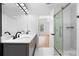 Bathroom featuring marble tile, walk-in shower with glass door, and double sink vanity at 4221 Rogers Creek Ct, Duluth, GA 30096