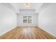 This bedroom has a tray ceiling, ceiling fan, light colored walls and a window overlooking the outdoors at 4221 Rogers Creek Ct, Duluth, GA 30096