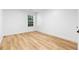Bright bedroom features light wood flooring, white walls, and a window with blinds at 4221 Rogers Creek Ct, Duluth, GA 30096