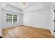 Bright bedroom featuring a trey ceiling, large window, and hardwood floors at 4221 Rogers Creek Ct, Duluth, GA 30096